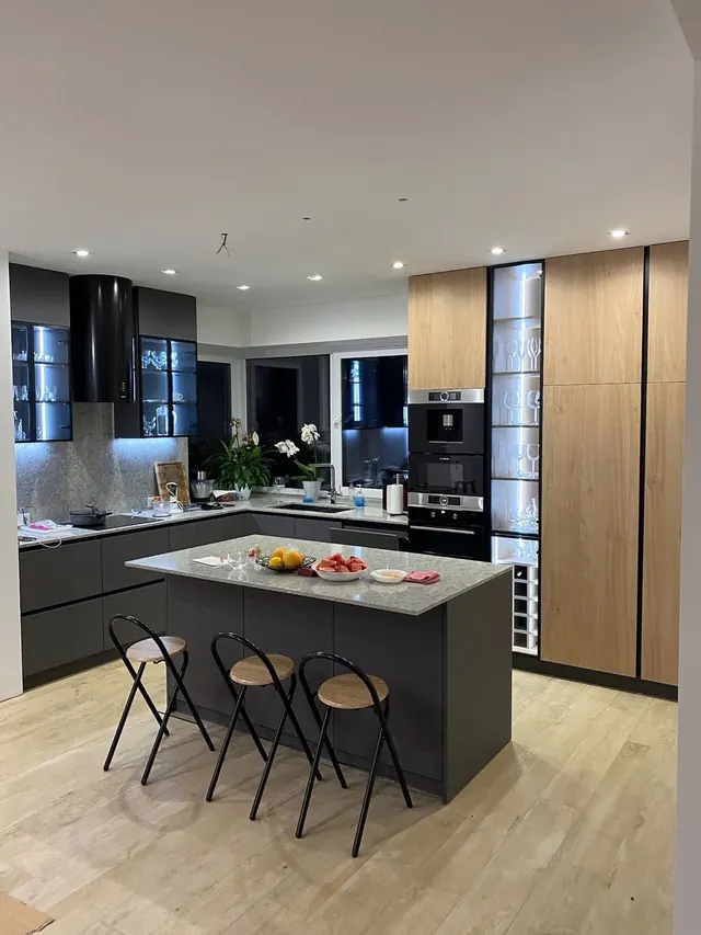 Kitchen with island and glass display cabinet