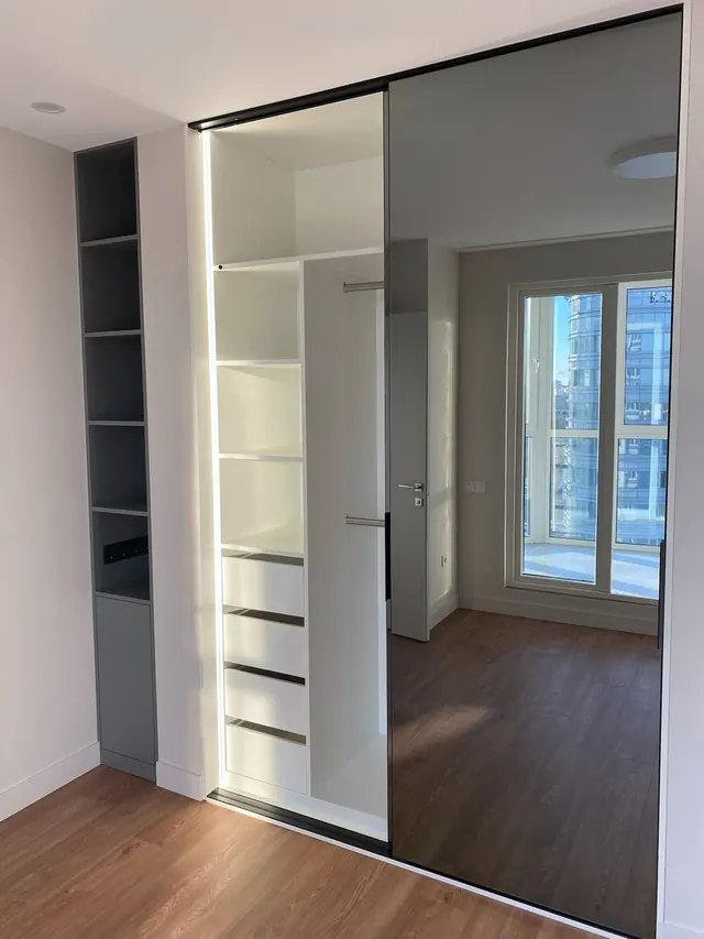 Sliding mirror wardrobe with lit interior